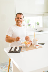 Middle age man eating asian food at home