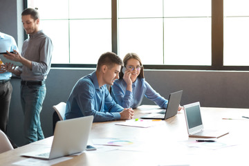 Young people having business meeting in modern office