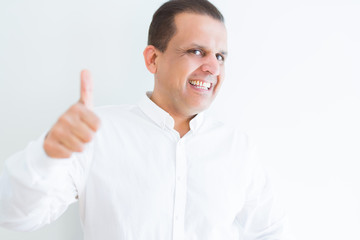 Middle age man doing postive gesture with thumbs up smiling to the camera