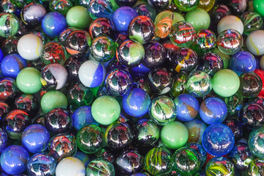 Group colorful glass marbles different color for decorate garden or fish aquarium,multicolor background,transparent oval shape crystal ball rainbow