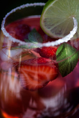 Strawberry lemonade drink, refreshing summer mojito with strawberries, lime and mint.