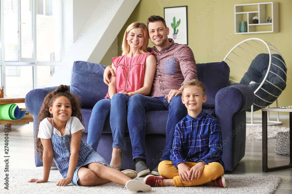 Poster Happy couple with little adopted children at home