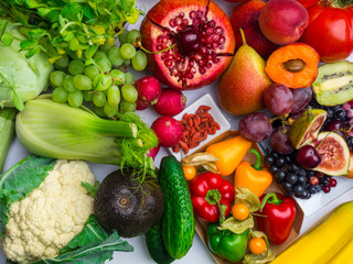 Arrangement of different colorful tasty vegetables fruits rich in vitamin, antioxidants background....