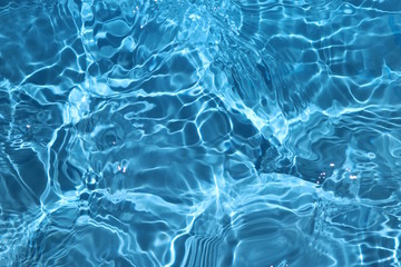 Blue and bright water surface with sun refection in swimming pool for background  - obrazy, fototapety, plakaty