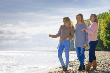 Three fashionable models pointing outdoor