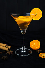 orange cocktail, Christmas hot drink in glass with orange, cinnamon, star anise, Clove.