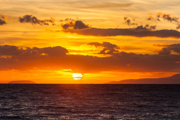 Sunrise or sunset over sea surface