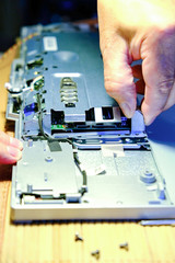 Service maintenance of computers. The wizard replaces the RAM, increasing the performance of the computer. Master removes the protective film.