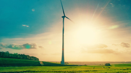 Lonely wind generator in the rays of the bright sun