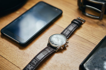 different accessories of a businessman for creating a style of a people lie on a wooden background