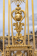 The golden entrance gate of the famous Palace of Versailles. Palace Versailles was a royal chateau. Versailles, Paris, France.