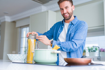 Handsome man cooking pasta at home