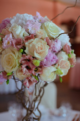 bouquet of flowers on a leg in the interior of the restaurant for the celebration of the flower shop wedding salon