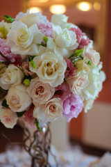 bouquet of flowers on a leg in the interior of the restaurant for the celebration of the flower shop wedding salon