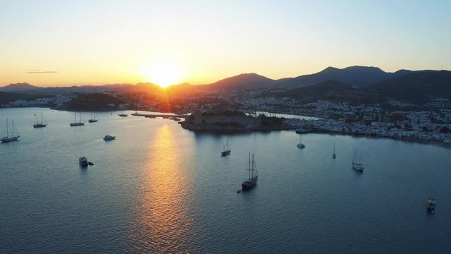 Bodrum bay and anceint Castle of Saint Peter at the sunset. Yachts moored in the bay of resort town in mediterranean sea 4k