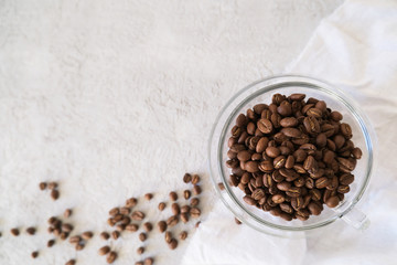 Aroma frame fot text made of glass cup coffee beans on gray background with copyspace. Flat lay, top. view. Beverages, morning and cafe concept