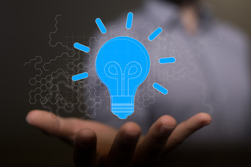  holding illuminated light bulb, idea, innovation and inspiration concept.