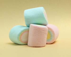 colorful marshmallows candy  on yellow background