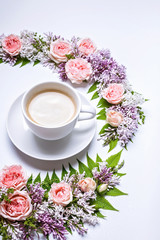 Obraz na płótnie Canvas Vertical web banner. Frame of flowers: rose, lilac, rowan leaves and cup coffee on a white background. Floral pattern.