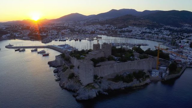 Anceint Castle of St. Peter at the sunset. Yachts moored in the bay of resort town in mediterranean sea 4k