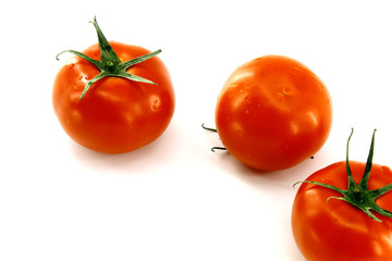Three red fresh tomatoes on white background