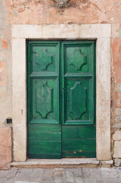 Od green door on an old medieval building.