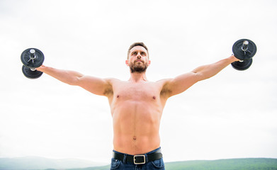 Muscular man exercising with dumbbell. Dumbbell exercise. Strong biceps and triceps. Gym workout....