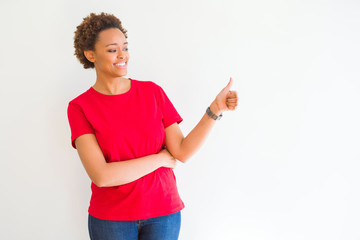 Young beautiful african american woman over white background Looking proud, smiling doing thumbs up gesture to the side