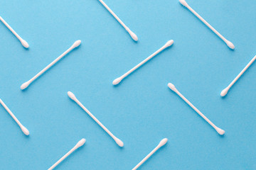 white cotton swabs on blue background, abstract pattern, closeup