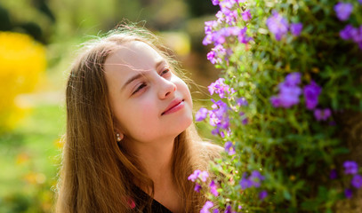 Naklejka premium Peaceful environment garden. Enjoying nature. Kid cute fancy child spend time in park. Explore garden. Excursion to botanical garden. Spring bloom fragrance. Girl teen walk in botanical garden