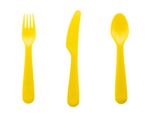 set of yellow plastic spoon, fork and knife isolated on white background