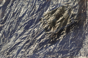 Crumpled Plastic wrap texture background for ecological concepts. accumulation in the environment of synthetic plastic products creates problems for wildlife.