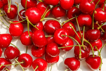 tasty and sweet organic farm cherries, background, top view. A cherry is the fruit of many plants of the genus Prunus, and is a fleshy drupe