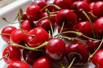 Sweet cherry close-up, lies on a white tray. Antioxidant, eco, vitamin, farm berry. Selective focus. Macro background.