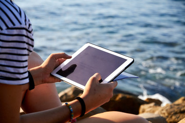 girl reading on a mobile tablet