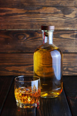 Bottle of whiskey on a wooden background.Studio photography.
