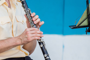 Fototapeta premium The man plays the clarinet during the concert_