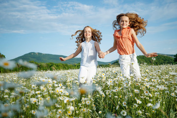 Beautiful children in the field with flowers. 