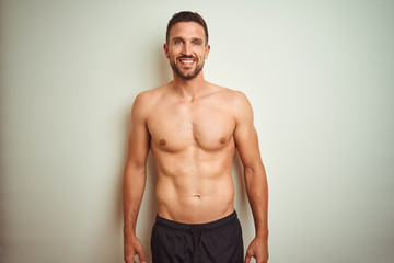 Fototapeta premium Young handsome shirtless man over isolated background with a happy and cool smile on face. Lucky person.