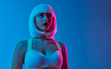 Futuristic woman in bra looking away