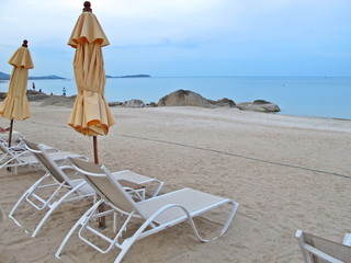 Fototapeta na wymiar Bed beach and yellow umbrella on tropical beach in the summer morning. Nature and travel concept.