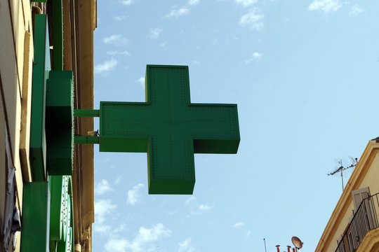 Picture of a green cross a universal pharmacy emblem, symbol.