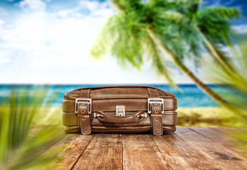 Summer retro suitcase on desk and beach landscape 