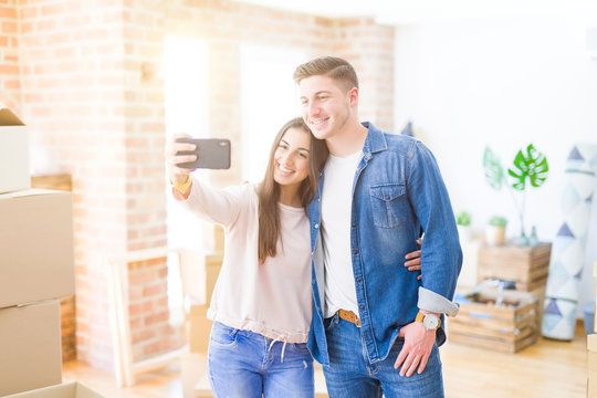 Beautiful young couple smiling happy taking a selfie photo with smartphone, very excited moving to a new home