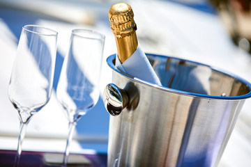Romantic luxury evening on cruise yacht with champagne setting. Empty glasses and bottle with...