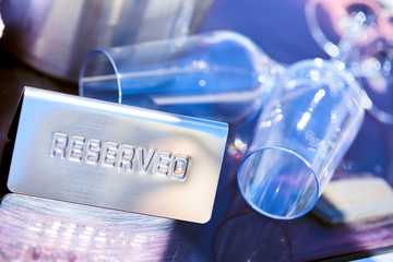 Romantic luxury evening on cruise yacht with champagne setting. Empty glasses and bottle with champagne and tropical sunset with sea background