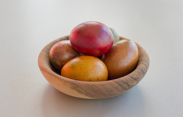 Top view of colored chicken eggs on white background