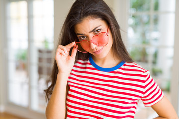 Young beautiful woman smiling cheerful wearing glasses looking happy with a big smile