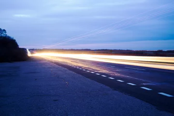 Foto op Aluminium Night road and light from the headlights outside the city © kudryshanna