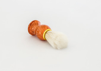 White  shaving brush with wooden handle isolated on a white background